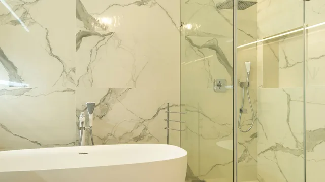 Tile setter working on shower walls in Newark, NJ